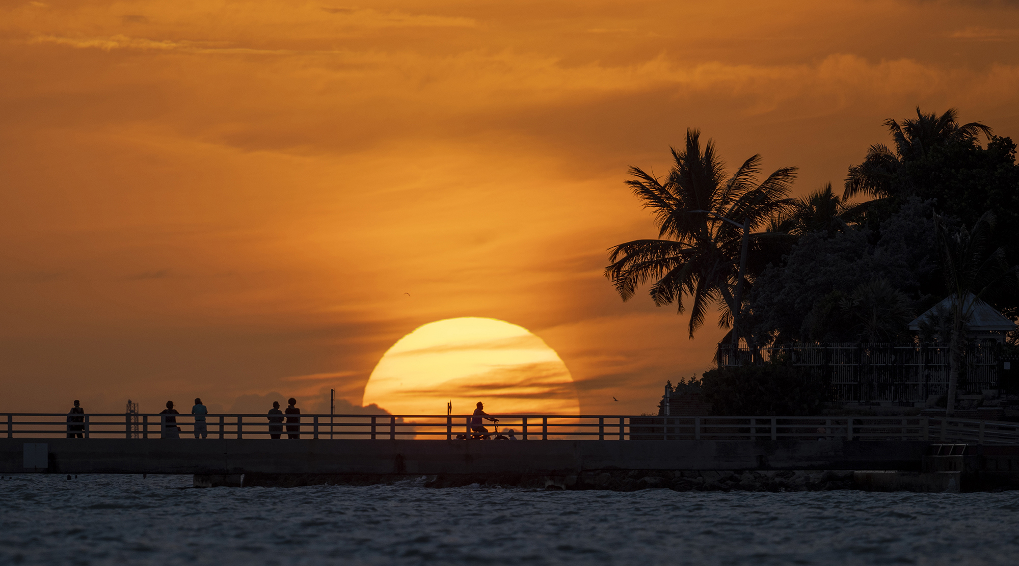 sunset on white street pier